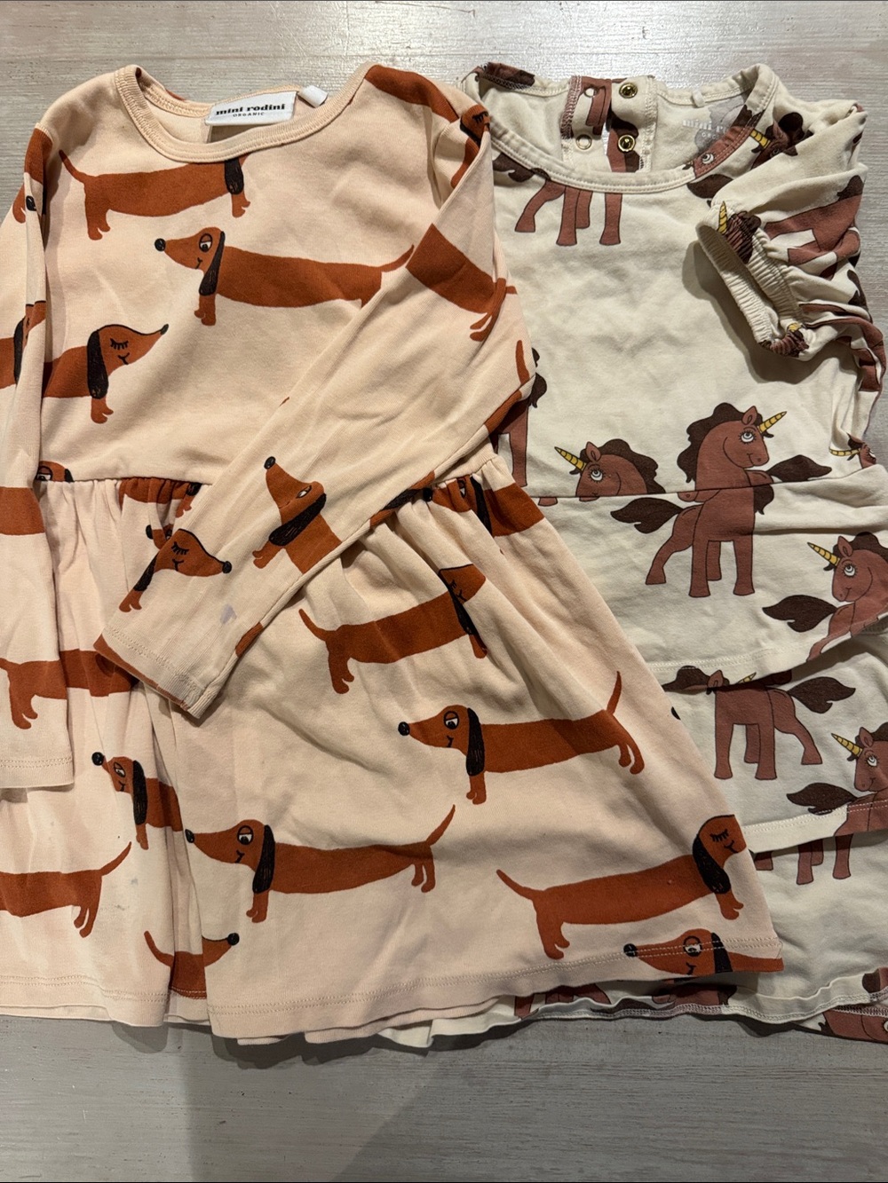 2 Mini Rodini Cream & peach Dresses with fun prints